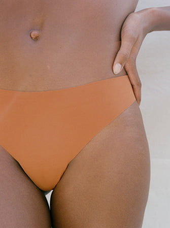 Kit Undergarments Seamless Thong in Cinnamon, 63% nylon, 37% spandex