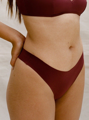 Kit Undergarments Seamless Thong in Garnet, 63% nylon, 37% spandex